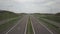 Panorama of the motorway with a bird`s eye view. Transport artery of the country. The movement of vehicles on the highway. Landsca