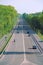 Panorama of motorway with cars and green trees on sides of road