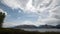 Panorama of Mount Moran and Grand Teton Peaks under cumulus clouds at Jackson Lake in Grand Teton National Park in Wyoming USA