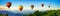 Panorama of mountain with hot air balloons on morning