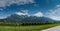 Panorama mountain landscape with many rows of Pinot Noir grapevines in the foreground