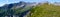 Panorama mountain landscape in the Swiss Alps with a great view of the Pizol mountains and hikers in the distance