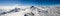 Panorama mountain landscape in the Swiss Alps near Zermatt on a beautiful day in late winter under a blue sky