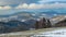 Panorama on mountain peaks with low hanging clouds