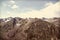 Panorama of a mountain range with gray clouds.