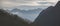 Panorama of the mountain range and slopes of the mountains in the early morning in the mountains of the Caucasus