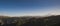 Panorama of a mountain range with snow and glaciers and Mount Elbrus