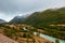 Panorama of mountain river on background of beautiful mountains in cloudy weather. View of turquoise river in the