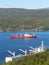 Panorama of the Mumansk sea port on a sunny summer gay. Cranes, cargo ships, Ð½eavy loading and unloading operations