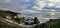 Panorama of Muriwai beach. Sunset under stormy sky