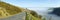 Panorama narrow road Welsh hills morning mist.