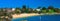 Panorama night view of Sydney Harbour beach of Camp Cove turquoise blue waters and sky golden sand lush green trees Australia