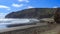 Panorama of O`Neill Bay, a black sand beach in the western Auckland Region, New Zealand