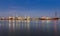 Panorama of Oil refinery at twilight along with river reflexion