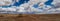 A panorama of an old corral, abandoned in the desert of Arizona under a blue sky with bright white