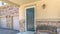 Panorama Old porch bench against stone brick wall of home with green wood front door