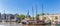 Panorama of old wooden sailing ships in the harbor of Gouda