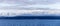 A panorama of the Olympic mountains of Washington State viewed from across the water