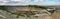 Panorama of opencast mining quarry with machinery.