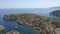 Panorama over the ocean. Lots of rocks, calm water and ships in the bay. 4K Slow Mo