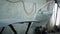 Panorama of painting chamber in an auto repair shop with car parts, hood and doors are fixing on stands