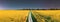 panorama, panoramic Elevated View Night Starry Sky Above Country road through Field With Flowering Blooming Oilseed