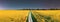 panorama, panoramic Elevated View Night Starry Sky Above Country road through Field With Flowering Blooming Oilseed