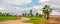 Panorama of Paphos city promenade with green grass, pathway, buildings and palm trees on coastline. Cyprus travel