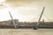 Panorama of peace bridge in Derry or Londonderry spanning across the river on a sunny spring day. Beautiful modernist bridge to