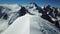Panorama of the peak with tourists. The achievement of the goal height! Blue sky and snowy mountains.
