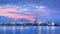 Panorama of a petrochemical production plant against a dramatic colored sky at twilight, Port of Antwerp, Belgium.