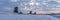 Panorama photo of a sunrise on a cold winter morning with a snowy landscape at the three windmills in Leidschendam, The Netherland