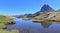 Panorama of Pic du Midi d\\\'Ossau & reflection in the clear waters of Lac Roumassot, above Ossau Valley in the French Pyrenees