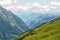 Panorama of picturesque blue mountainsides and green alpine meadows, Austria