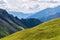 Panorama of picturesque blue mountainsides and green alpine meadows, Austria