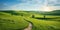 Panorama of picturesque mountain scenery in the Alps with fresh blooming green fields cutting the road on a sunny spring day,
