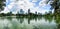 Panorama of Pond with Pedal boat at Lumpini park or Suan Lumpini, Bangkok, Thailand. Office buildings and condominiums with white