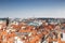 Panorama of Prague downtown with red roofs and Charles bridge tower