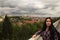 Panorama of Prague. Portrait of young brunette woman.
