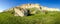 Panorama of the precipitous edge of limestone plateau against sky