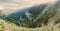 Panorama of the precipitous hillside with forest at sunset