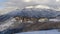 Panorama Pristine landscape of Wasatch Mountains with houses on its snow covered terrain