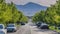 Panorama Puffy clouds at sunset Concrete road with vehicles parked on the roadside near the colu