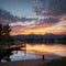 Panorama Puffy clouds at sunset Four wooden lounge chairs facing the reflective Oquirrh Lake at Daybreak, Utah. Wooden