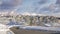 Panorama Puffy clouds at sunset Plowed road in the snow covered residential community of Draper