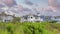 Panorama Puffy clouds at sunset Three large houses with glass fence at Newport Beach, Orange Cou