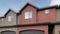 Panorama Puffy clouds at sunset Townhouse exterior with garage and sliding glass windows