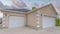 Panorama Puffy clouds at sunset Two white clipped corner garage doors with concrete driveway