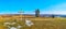 Panorama of Pyrohiv Skansen with hilly meadow, wooden cross and old windmills, Kyiv, Ukraine