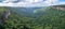 Panorama of rainforest and rugged cliffs.